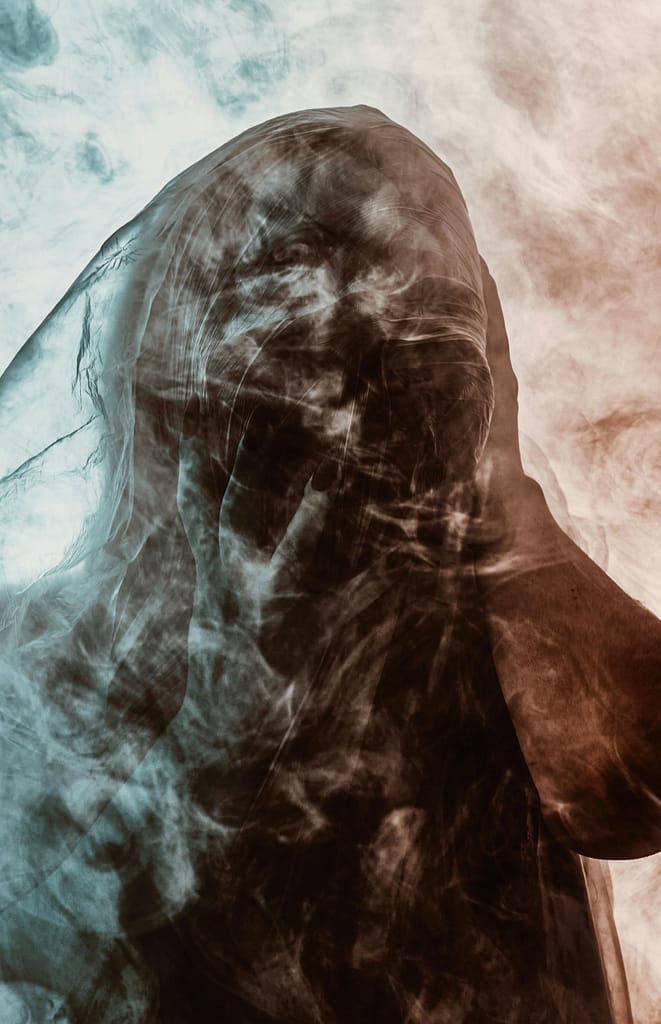 A mysterious figure veiled in smoke, symbolizing the subconscious and spiritual questions, evoking thoughts on is lucid dreaming a sin.