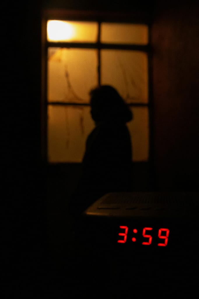 A dark woman's silhouette overthinking after midnight