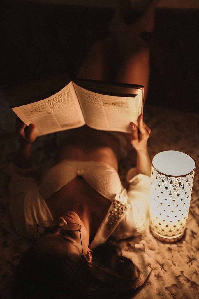 A woman in bed reading calmly a physics book to slow down her racing thoughts