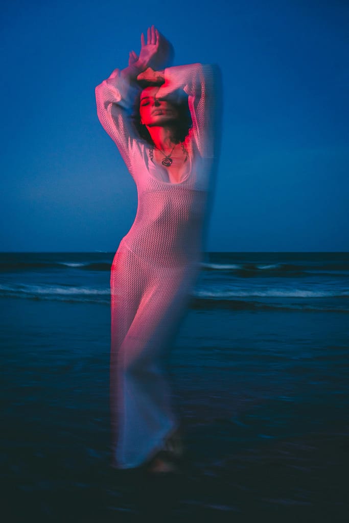 A blurred vision of a woman in a knitted dress by the ocean - because constantly dreaming about someone can interfere with your vision