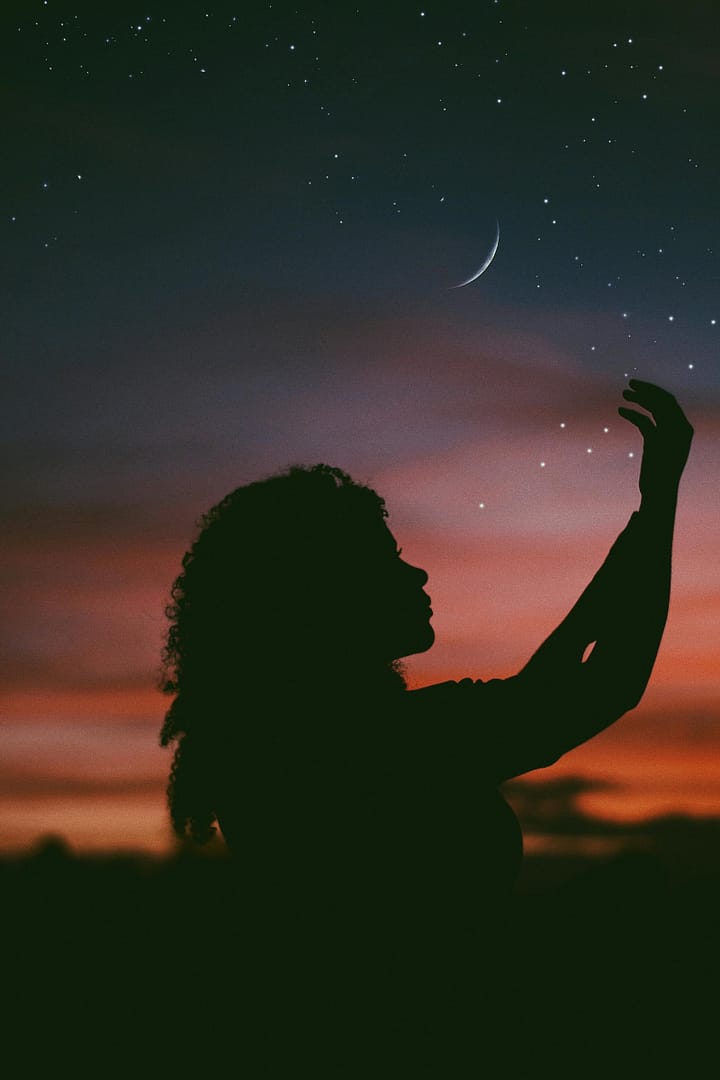 A woman learning how to lucid dream under the night starry sky