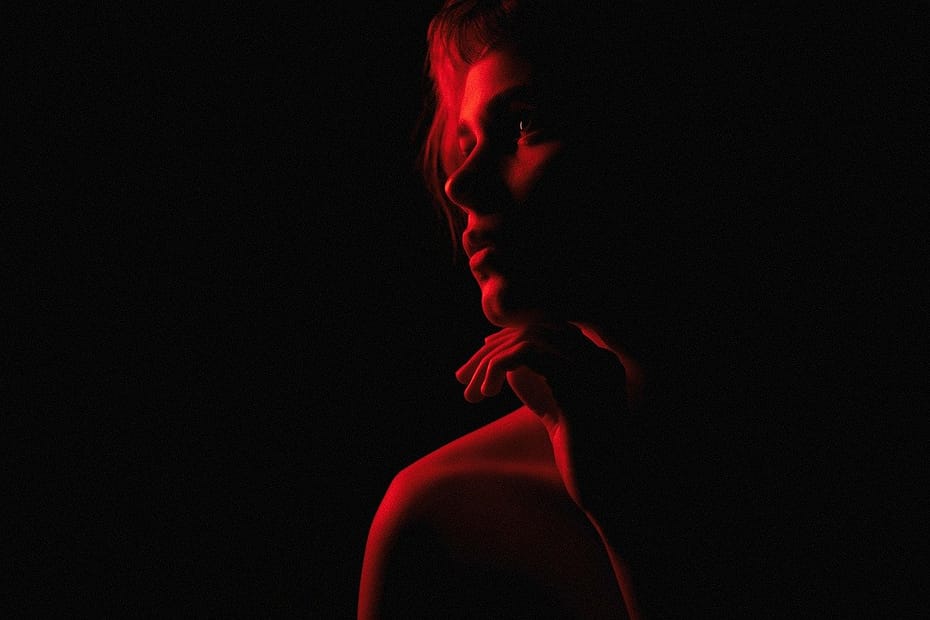 Female silhouette with red lighting effects. dark feminine aesthetic